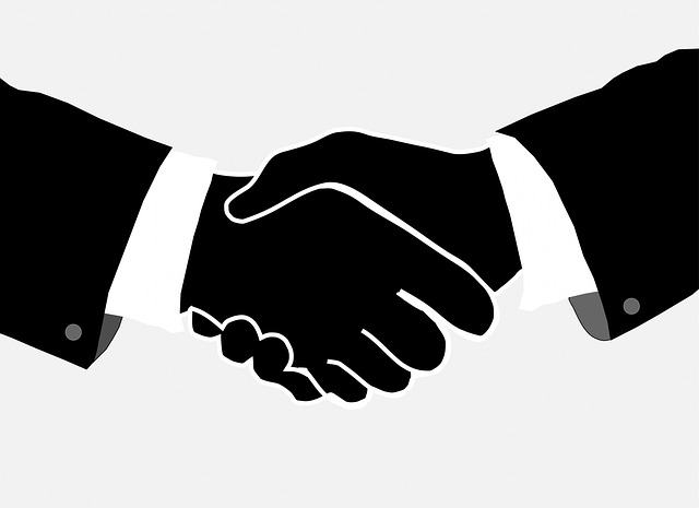 picture of a handshake and dealmaking
